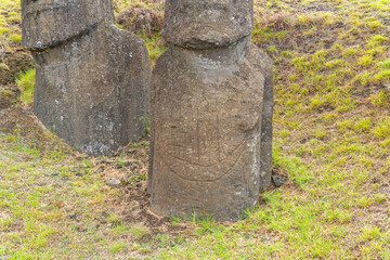 Close up of Moai Ko Kona He Roa (on the right) statue features a carving of a European ship on its front at Rano Raraku on Easter Island (Rapa Nui),  Chile. -2023