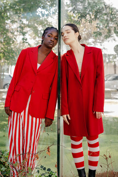 Models standing on opposite sides of wall
