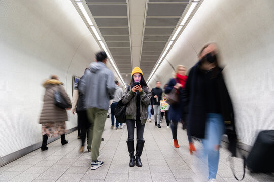 Woman Using Phone At Underground Station