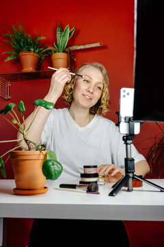 Female influencer shooting makeup tutorial