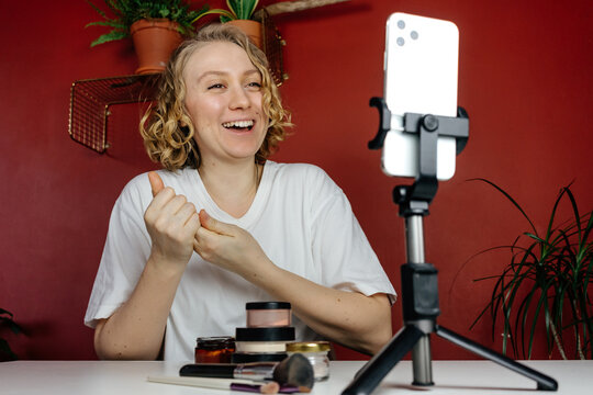 Female blogger laughing while talking with audience