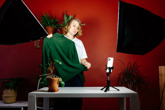 Fashion blogger showing green sweater