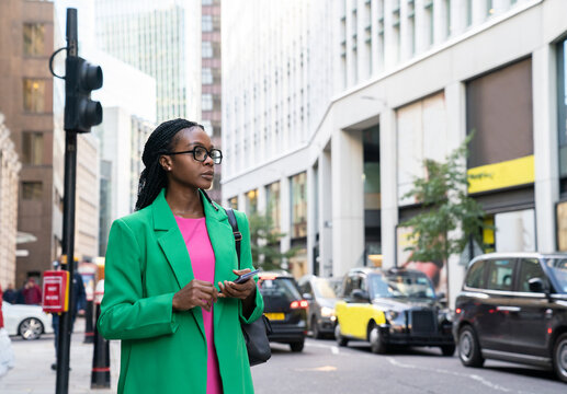 Black Woman Holding Phone Outdoors