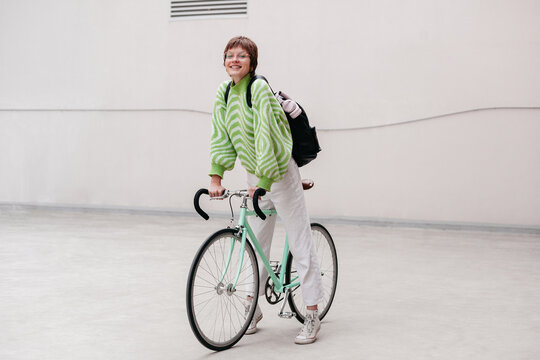 Stylish girl with vintage bicycle on street