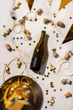 Bottle of wine on table sweets, confetti, holiday and champagne corks