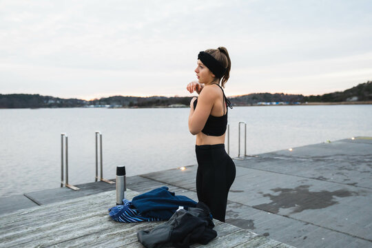 Young woman getting dressed after a swim