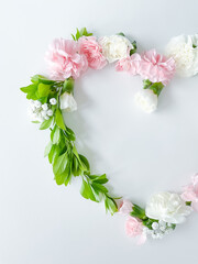 Frame in form of heart from pink, white carnations