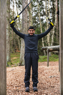Man working out with TRX in outdoor gym