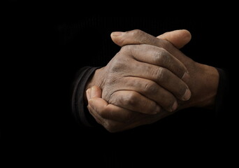 man praying to god with hands together Caribbean man praying with black background stock photos stock photo	