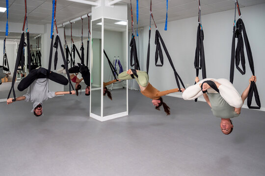 Group doing aerial inverted yoga