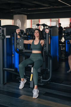 Woman exercising on chest fly machine