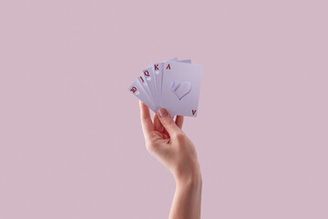 Cards with cut heart hollow in woman's hand.