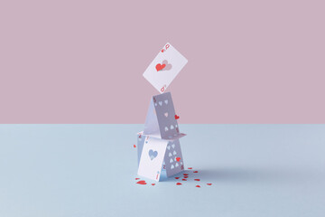 Paper card house with cut red paper hearts.
