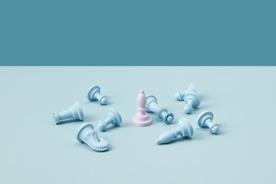 Fototapeta Pink bishop and fallen blue chess pieces.