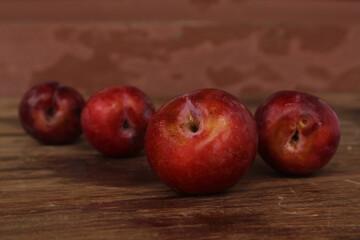 Red plum on wooden floor