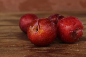 Red plum on wooden floor