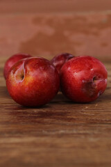Red plum on wooden floor