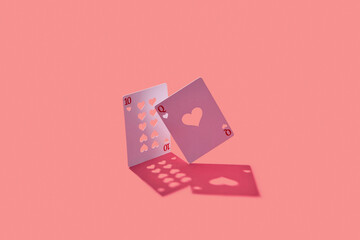 Queen and ten cards with cut hearts and shadow.