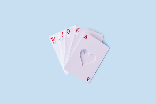 White deck of cards with cut hearts inside.