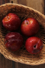 Red plum on wooden floor