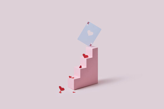 Paper craft steps with red hearts and white card.