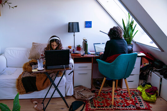 Two young women studying together in a room
