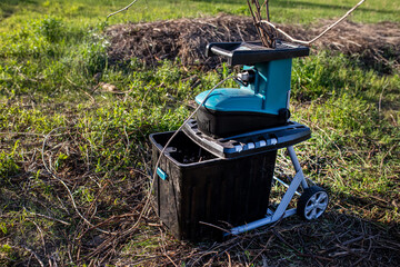 electric garden grinder to shred with a extended filled tank for crushed branches, ready for use in...