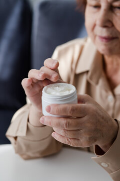 Senior Woman Applying Cream