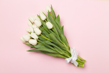 White tulip bouquet on color background, top view