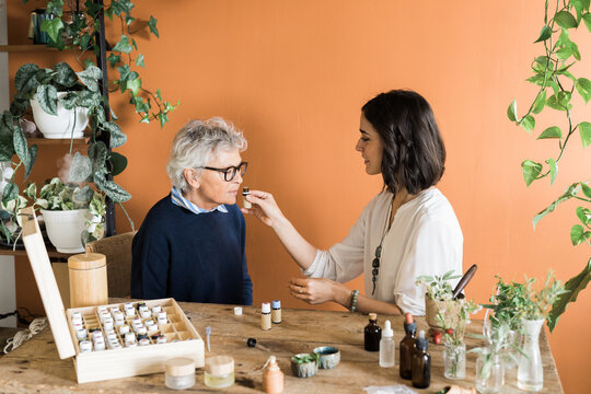 Naturopath And Patient Trying Essential Oils