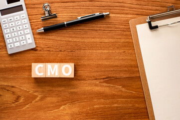 There is wood cube with the word CMO.It is an abbreviation for Chief Marketing Officer as eye-catching image.