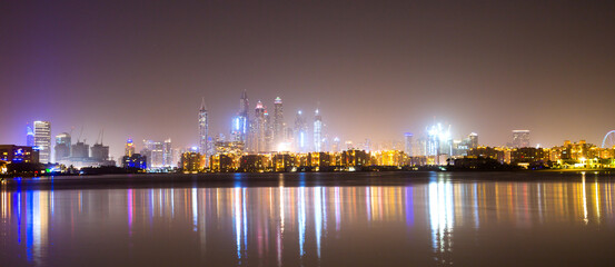 Fototapeta na wymiar Beautiful night view at Dubai Marina from the Palm Jumeirah at night. Dubai, UAE