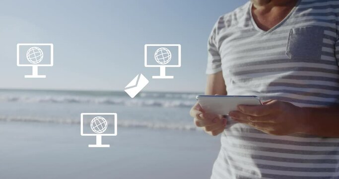 Animation of screen with globe icons over caucasian man using tablet