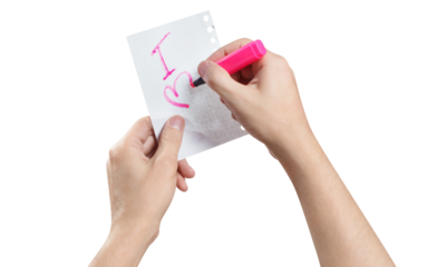 Hands writing a love note using a pink marker, cut out