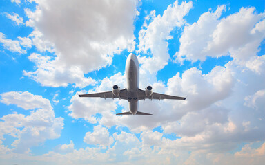 White passenger airplane flying in the sky amazing clouds in the background - Travel by air transport