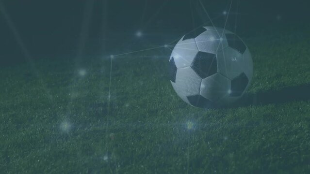 Animation of network of connections over football player with football on pitch