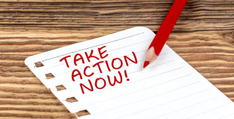 Word TAKE ACTION NOW on a paper with ped pencil on wooden background