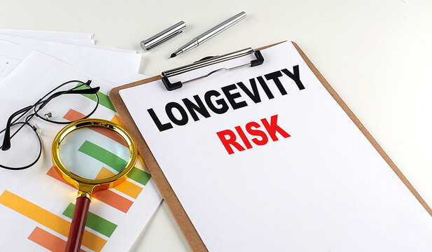 LONGEVITY RISK Text On Clipboard With Chart On White Background, Business Concept