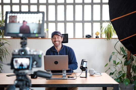 Smiling podcaster man in live streaming