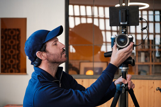 Camera operator preparing camera For filmming