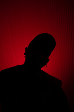 silhouette of an unrecognizable man against a red background