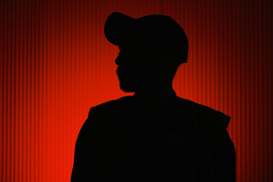 silhouette of an unrecognizable man against a red background
