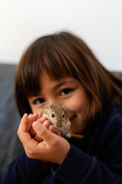 smiling girl and gerbil