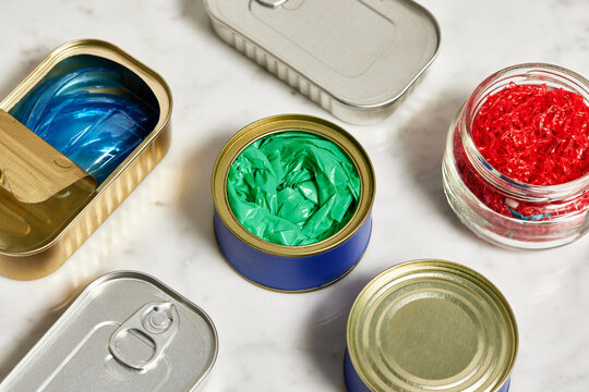 Plastic trash in tin cans and glass jar