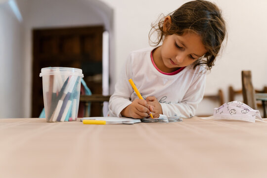 Cute girl drawing at desk