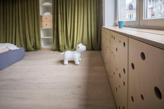 Loft style bedroom with modern light bed and toy at the floor
