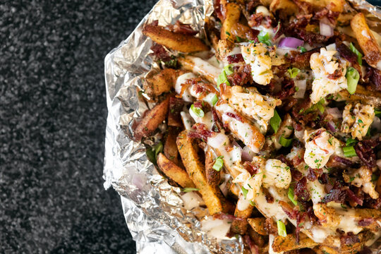 Fries Topped With Butter Poached Lobster And Cheese Sauce