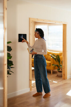 Woman using device in smart home