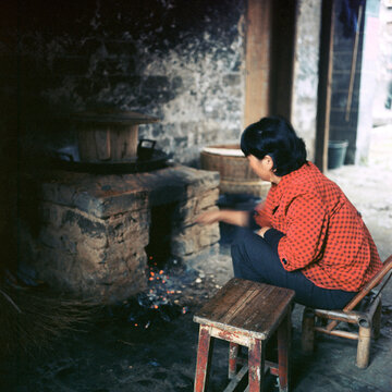 Aunt is burning firewood to cook