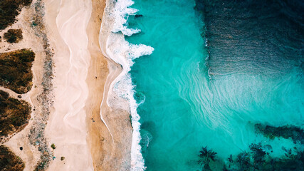 Fototapeta na wymiar Waves breaking on beach, aerial drone nature landscape from above